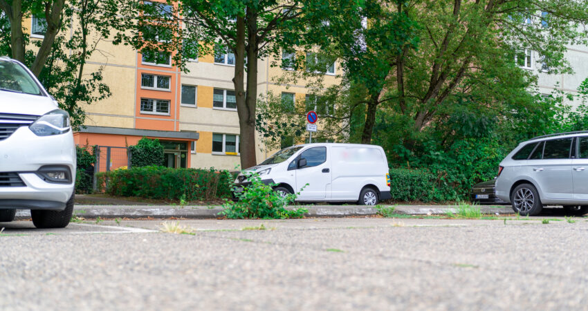 Leere Parkplätze zwischen Autos vor einem Wohnhaus